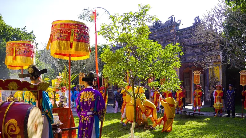 Performers in traditional royal costumes take part in a ceremonial tree-planting ritual at Hue's imperial citadel.