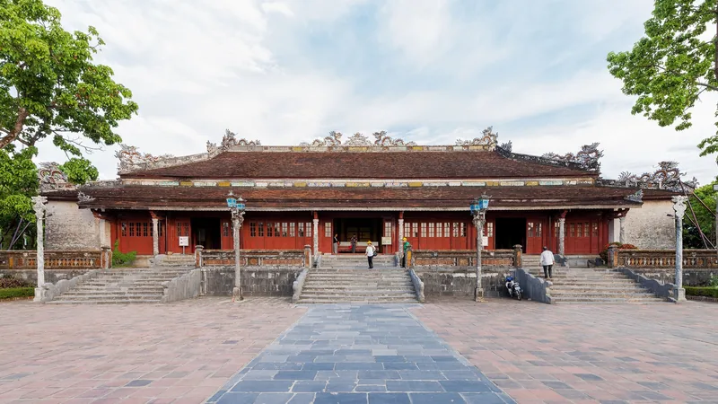 Thai Hoa Palace's ornate red-and-gold facade stands beneath a tiled roof within Hue's Imperial City.