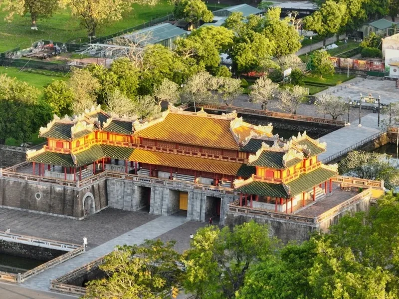 Aerial view of the Ngo Mon Gate entrance to Hue's Imperial Citadel surrounded by moats and greenery.